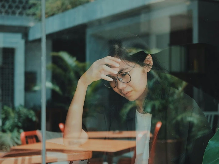 woman touching her forehead